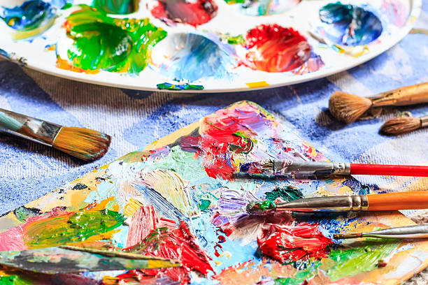 istock Colourful oil paint, different types of brushes and palette 522849116