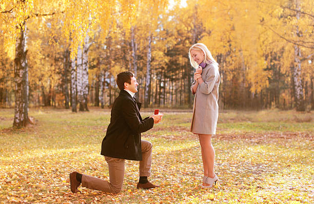 Love, couple, relationship and engagement concept - kneeled man stock photo