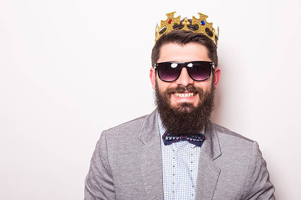 istock Portrait handsome young cheerful man in suit with crown 522851028