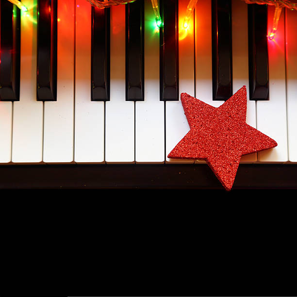 istock Christmas lights and ornament on piano keys 522851055