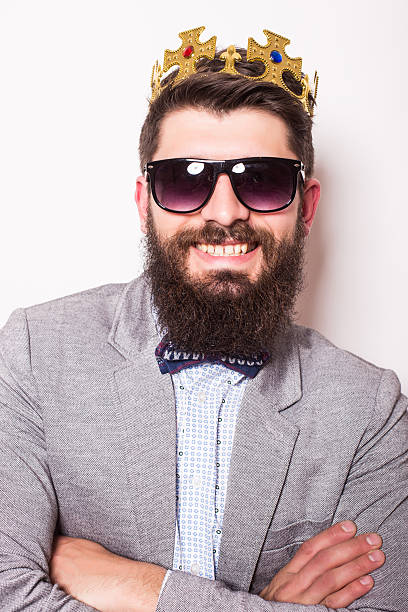 istock Portrait handsome man in suit with crown looking at camera 522851082