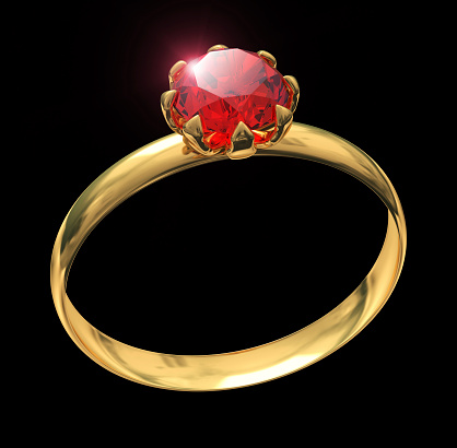 Closeup of golden ring with ruby gem isolated on black