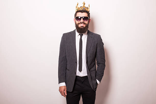 istock man in sunglasses  and crown keeping hand on jacket 522851168