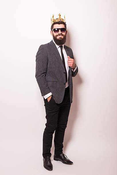 istock Young handsome man in sunglasses wearing suit and crown 522851208