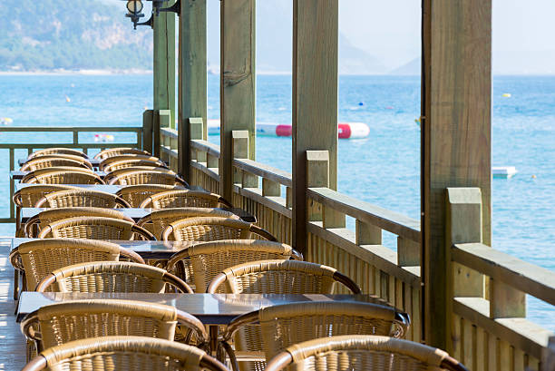 istock Cafe with wooden tables and chairs at  seaside 522851401