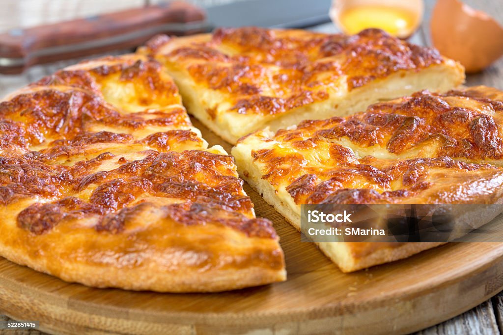 Slices of pie with cheese closeup. Slices of pie with cheese on wooden plate close up. Baked Stock Photo