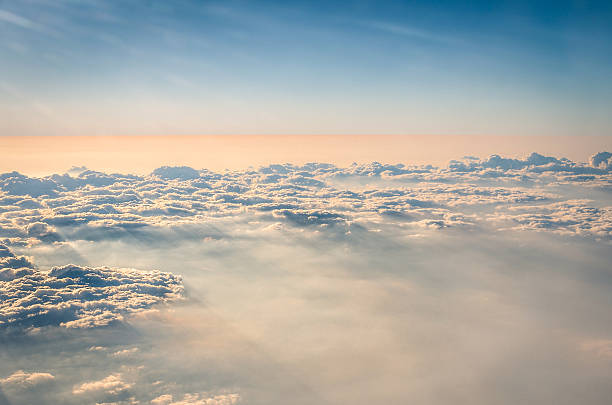 Aerial view of clouds and sky from airplane before sunset