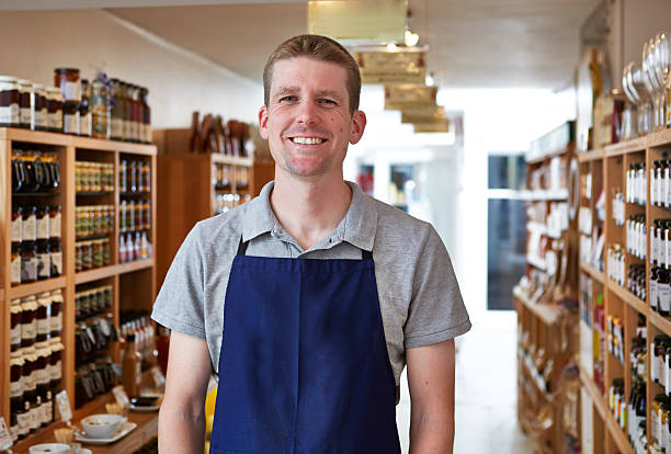 istock Smiling shop keeper in delicatessen 522852493