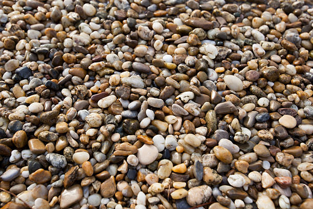 istock Brown pebble stone floor background seamless and texture 522852583
