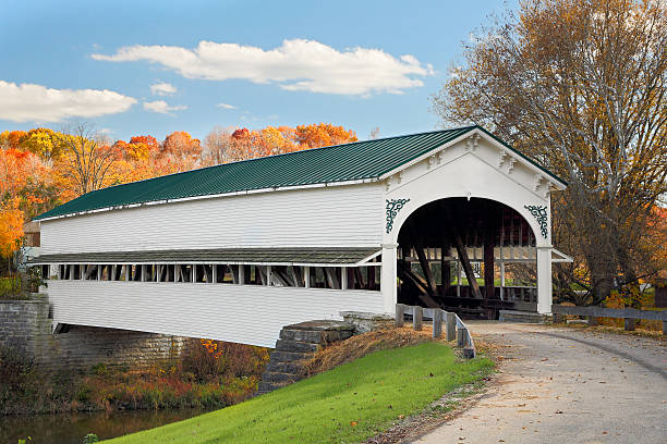 Covered Bridge at Westport The historic Westport Covered Bridge crosses Sand Creek in rural Decatur County, Indiana backed by colorful autumn foliage. indiana covered bridge stock pictures, royalty-free photos & images