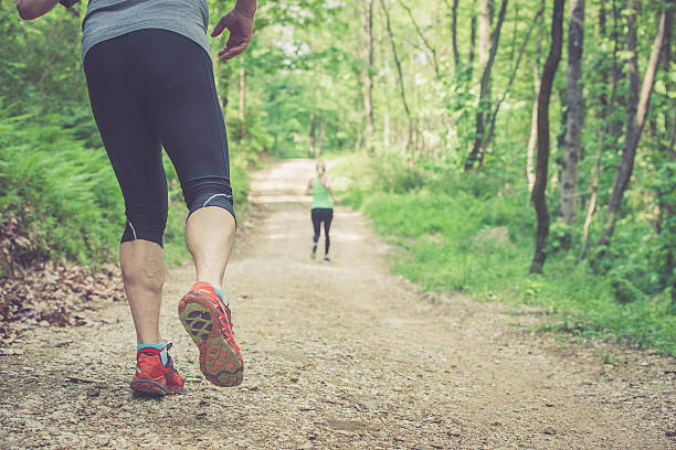 istock Young woman and elderly man running in the forest 522856704