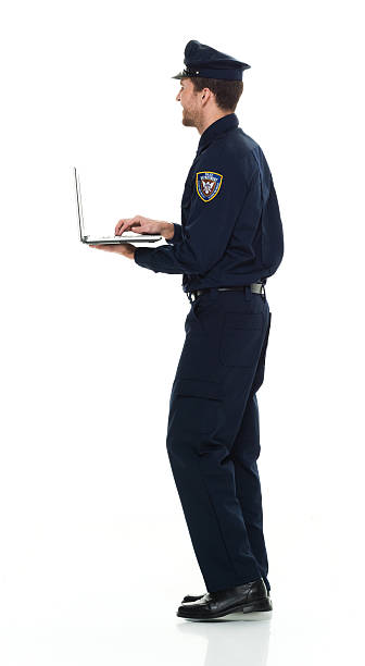 istock Smiling police working on laptop 522857344