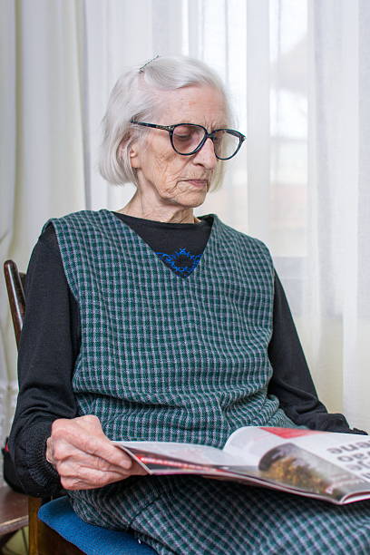 istock Ninety years old lady reading newspapers 522858194