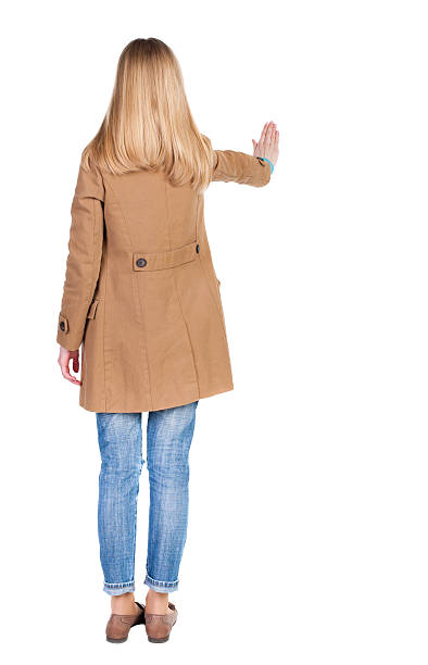 istock Young woman in cloak presses down on something. 522859538