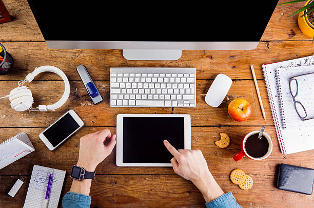 Business person working on tablet wearing smart watch