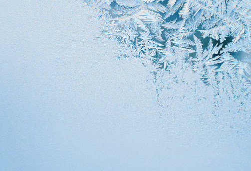 Ice background. Copy space. Frost pattern on glass. Cold weather.