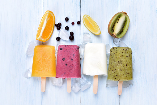 Homemade frozen ice cream popsicles from fruits, top view