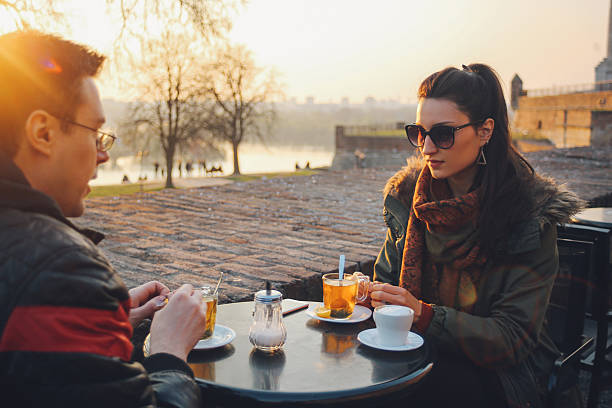 istock Young couple sitting in an outdoors cafe 522865960