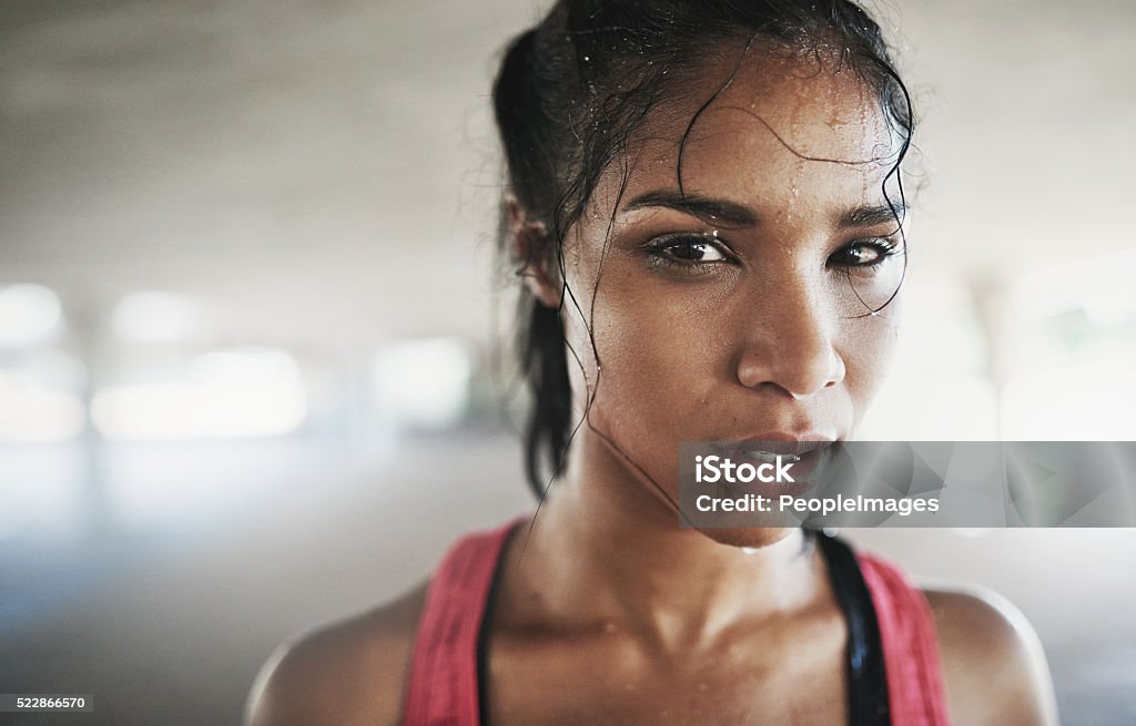 When my body shouts stop, my mind screams never Portrait of a sporty young woman looking serious while out for a run Sweat Stock Photo