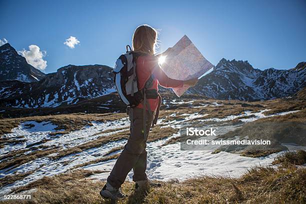 Young Tourist On Mountain Trail Reading A Mapautumn Stock Photo - Download Image Now