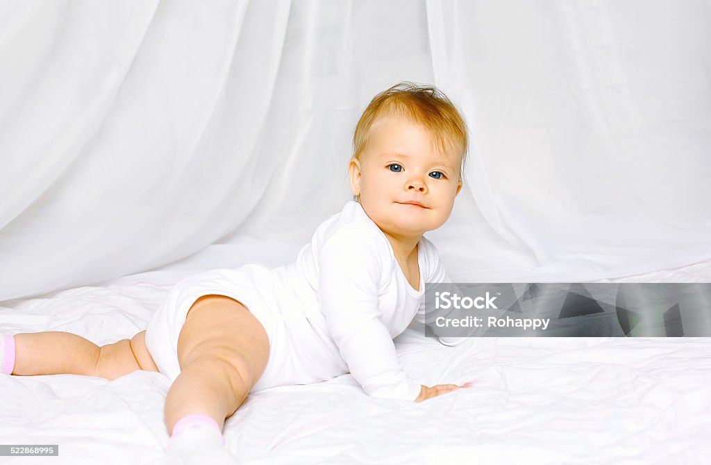 Portrait cute baby lying on the bed home 12-17 Months Stock Photo