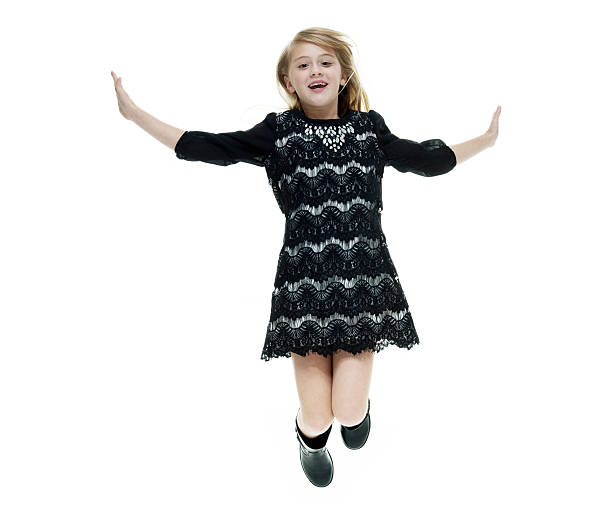 istock Smiling little girl jumping 522869184