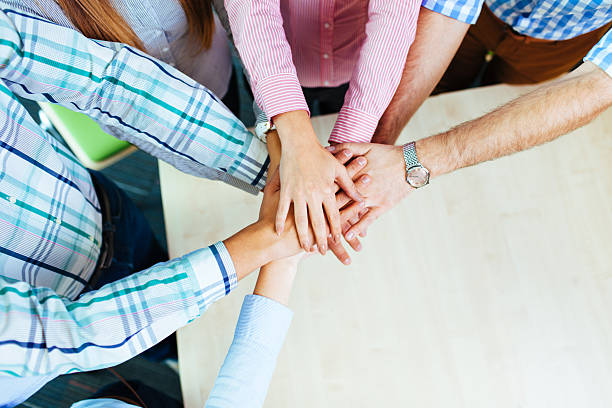 istock Group of corporate people working on new project joining hands 522870911