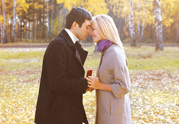 Love, couple, relationship and engagement concept - man proposin
