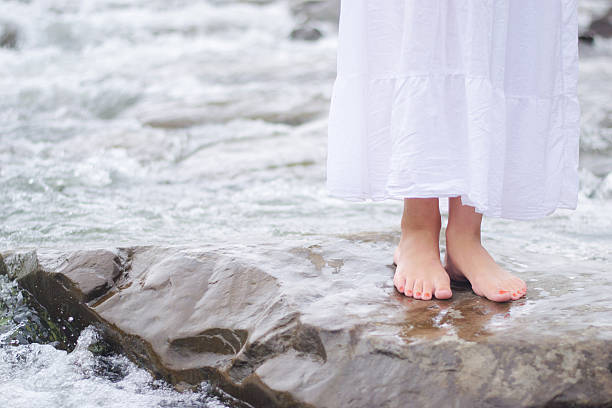 istock Girl soaking feet in stream 522871561