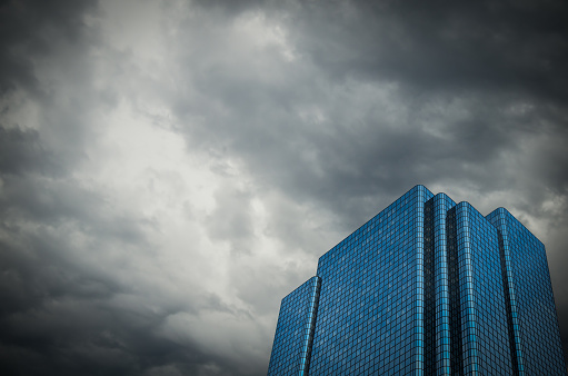 Conceptual Image Of A Financial Building Set Against A Stormy Sky Representing An Economic Crisis