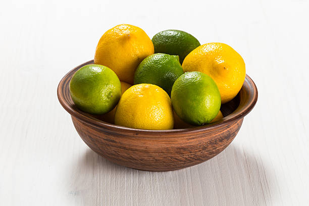 Lemons and limes in a clay bowl