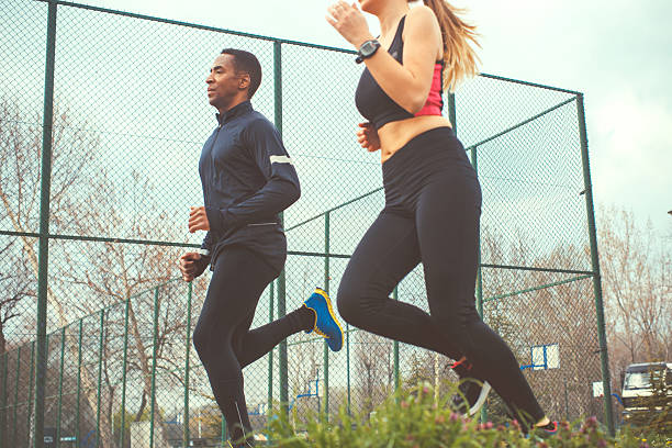 istock young woman running with her trainer 522873762