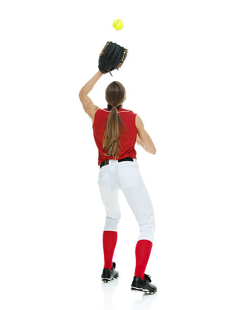 istock Rear view of softball player catching a ball 522874236