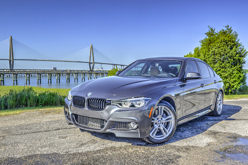 Mt Pleasant, South Carolina, USA - April 17, 2016: This is a picture of the new Bmw 3 series sedan 340i and is an example of the brand new 2016 model. Shot outdoors in the morning at Remley's Point in Mt Pleasant, SC. The Cooper River Bridge is seen in the background.