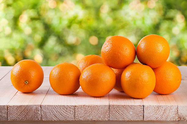 istock Fresh orange on wood with blur bokeh background 522878704