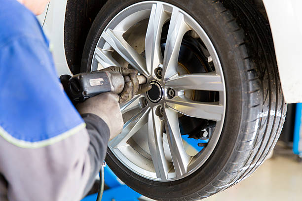istock Auto mechanic is changin tire...prepairing car for winter 522881015