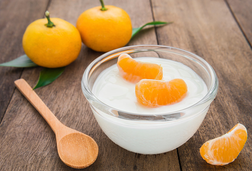 Fresh yogurt with orange fruit in bowl