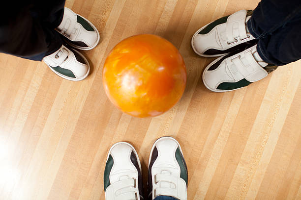 istock Three people at the bowling alley standing around  bowling ball 522892707
