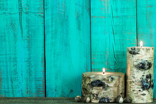 istock Textured log candles burning by antique green rustic wood background 522893633