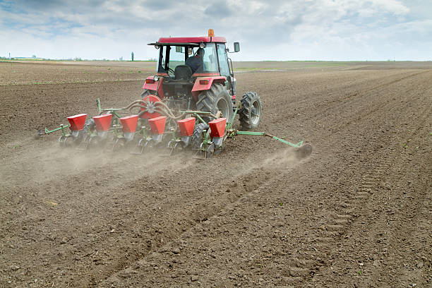 istock Farmer sowing crops with pneumatic seeding machine 522895347