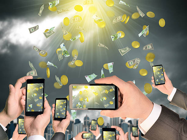 istock Hands holding smart phones and shoot video as falling money 522896011