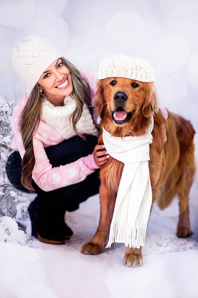 Winter woman with her dog ready to go out for a walk