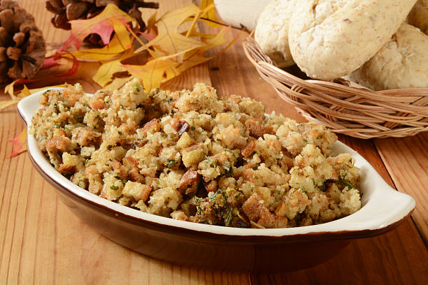 Turkey dressing A bowl of turkey stuffing with dinner rolls on a holiday table Stuffing stock pictures, royalty-free photos & images