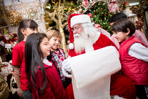 Santa with a shopping list and a group of kids