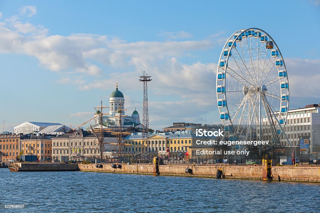 Quay of Helsinki with moored ships and ferris wheel Helsinki, Finland - September 13, 2014: central quay of Helsinki with moored ships, central Cathedral and ferris wheel Architectural Dome Stock Photo