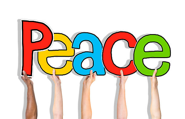 istock Multiethnic Group of Hands Holding Word Peace 522910761
