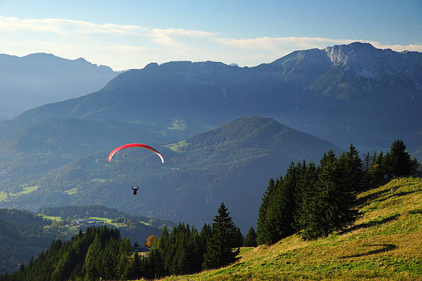istock Paraglider floats into the mountains 522913839