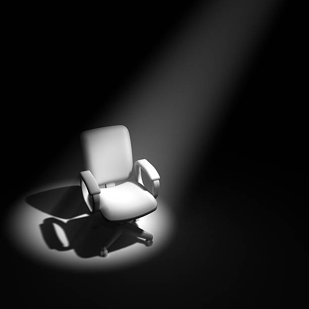 3d Office chair in spotlight 3d render of an office chair in a spotlight office chair stock pictures, royalty-free photos & images