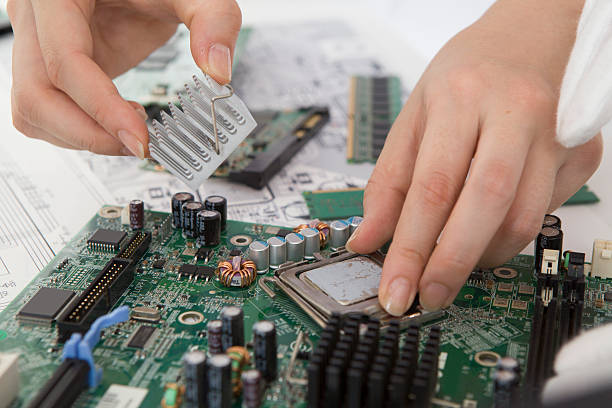 istock Woman who assemble the circuit board by hand 522915067