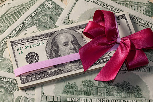 istock Pack of dollar bills with red bow 522921789